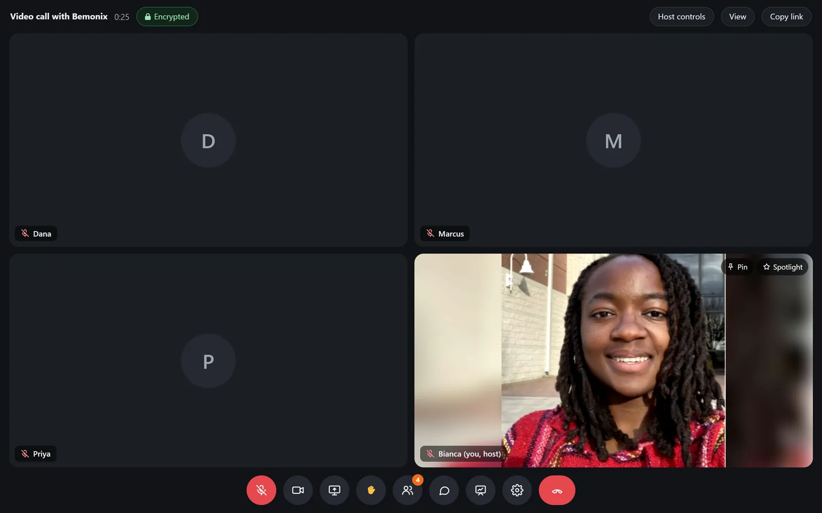 A video call in the app with four people, one on camera, and the call controls